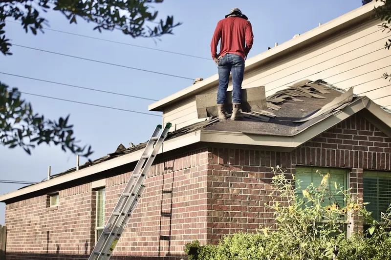 Professional roofer working on a residential roof in Channelview